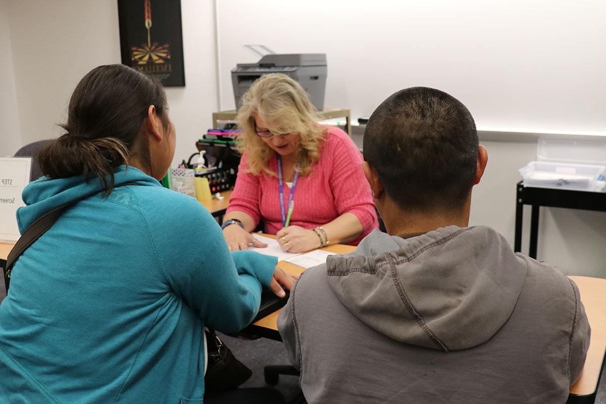 A couple has their taxes prepared by a volunteer.